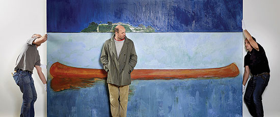 Painter Peter Doig with two assistants in front of a canvas from his 2001 painting series 