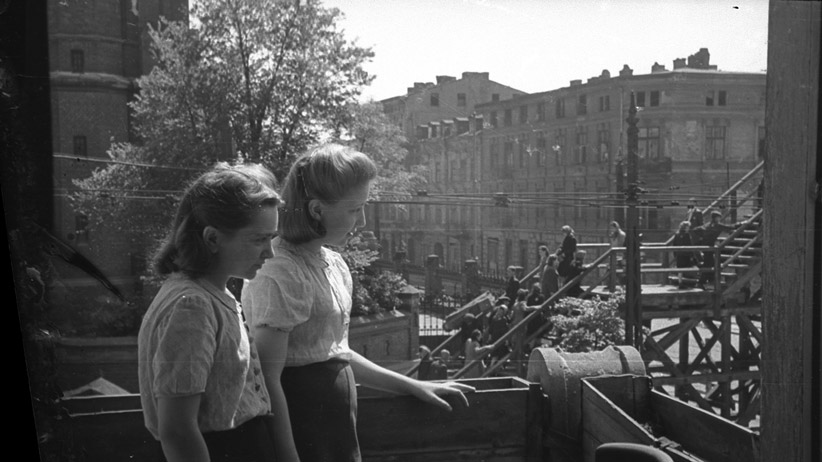 Henryk Ross Lodz ghetto: Two female employees of the Statistics observing the bridge at Koscielyn Square crossing Zigerska Street,